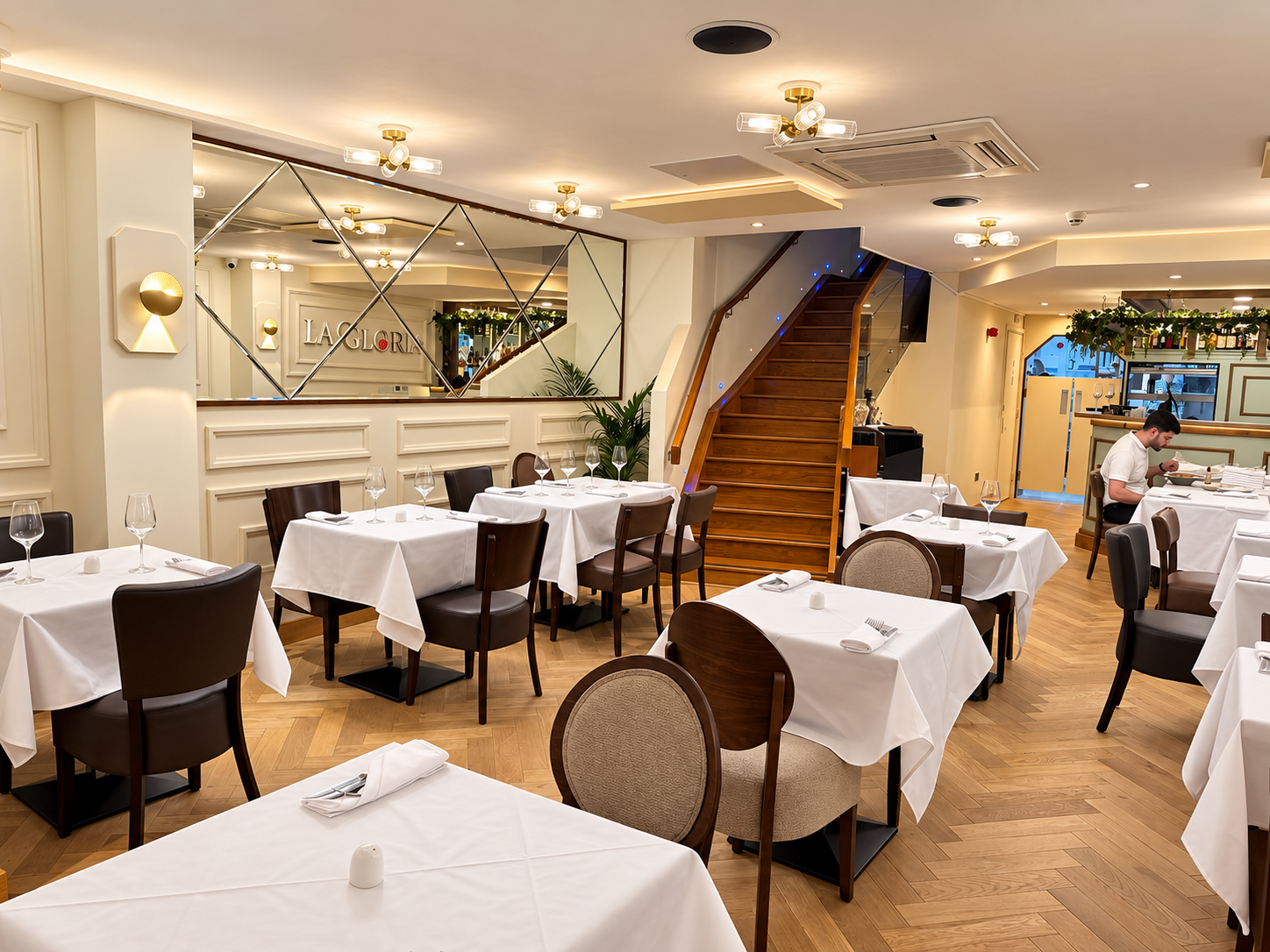 La Gloria main dining room with staircase and white table settings