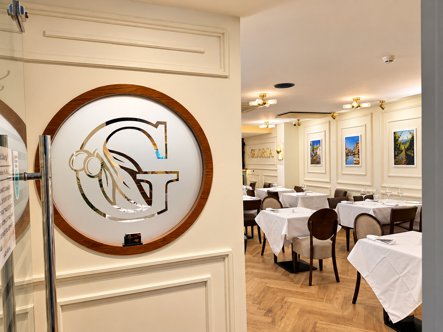 La Gloria illuminated entrance logo and dining room