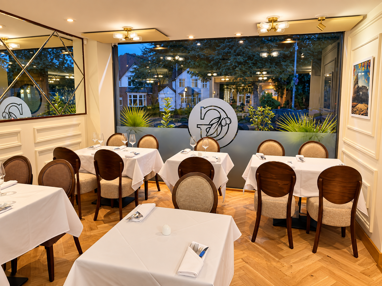La Gloria window dining area with white table settings
